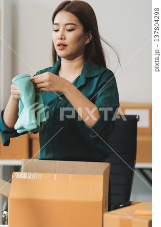 Starting small businesses SME owners female entrepreneurs check online orders to prepare to pack the boxes, sell to customers, sme business ideas online. 137804298