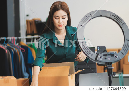 Starting small businesses SME owners female entrepreneurs check online orders to prepare to pack the boxes, sell to customers, sme business ideas online. 137804299