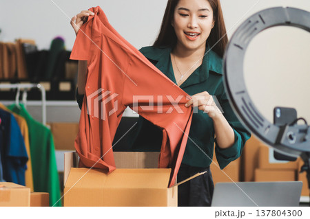 Starting small businesses SME owners female entrepreneurs check online orders to prepare to pack the boxes, sell to customers, sme business ideas online. 137804300