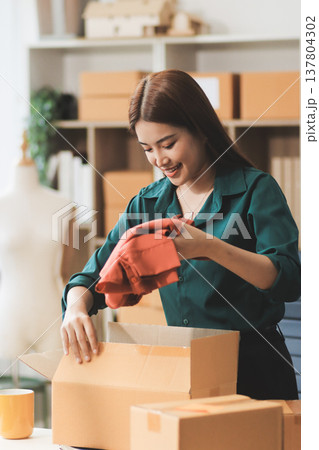 Starting small businesses SME owners female entrepreneurs check online orders to prepare to pack the boxes, sell to customers, sme business ideas online. Starting small businesses SME owners female entrepreneurs check online orders to prepare to pack the boxes, sell to customers, sme business ideas online. 137804302