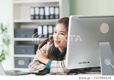 Pain, headache and stressed finance manager feeling sick, tired and worried about a financial problem at her startup company. Young and frustrated professional businesswoman working at an office 137804326