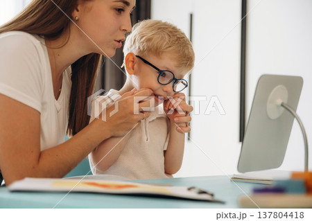 Speaking correctly, right way. Speech therapist is with young boy indoors 137804418