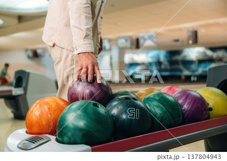 Taking the ball. Close up view of man that is playing bowling 137804943