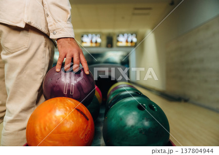 Taking the ball. Close up view of man that is playing bowling 137804944
