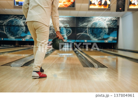 About to throw the ball. Close up view of man that is playing bowling 137804961