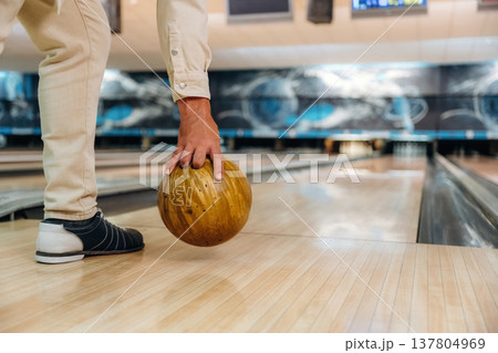 About to throw the ball. Close up view of man that is playing bowling About to throw the ball. Close up view of man that is playing bowling 137804969