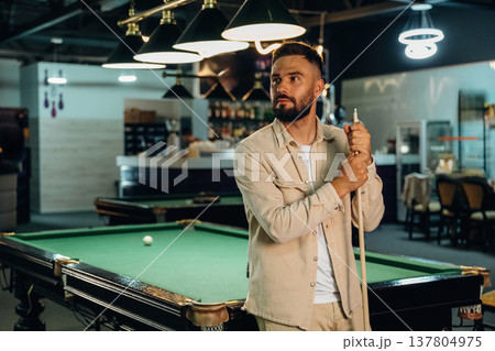 Handsome man with a pool table game 137804975