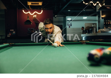 Focused, playing. Handsome man with a pool table game 137804984