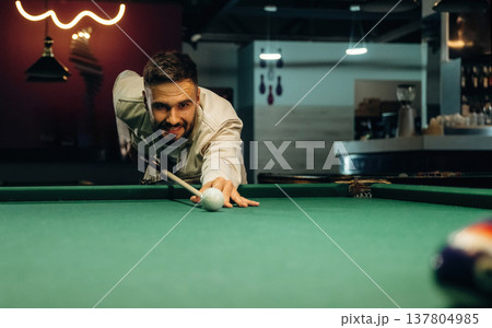 Focused, playing. Handsome man with a pool table game 137804985