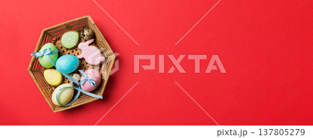 Colorful easter cookies in basket with Multi colors Easter eggs on colored background . Pastel color Easter eggs. holiday concept with copy space 137805279