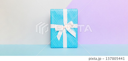 holiday handmade paper present tied white ribbon bow top view with copy space. Flat lay holiday background. Birthday or christmas present. Christmas gift box concept with copy space 137805441