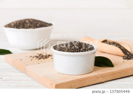 Chia seeds in bowl and spoon on colored background. Healthy Salvia hispanica in small bowl. Healthy superfood 137805449