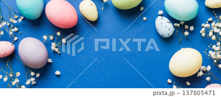 Happy Easter composition. Easter eggs on colored table with gypsophila. Natural dyed colorful eggs background top view with copy space Happy Easter composition. Easter eggs on colored table with gypsophila. Natural dyed colorful eggs background top view with copy space 137805471