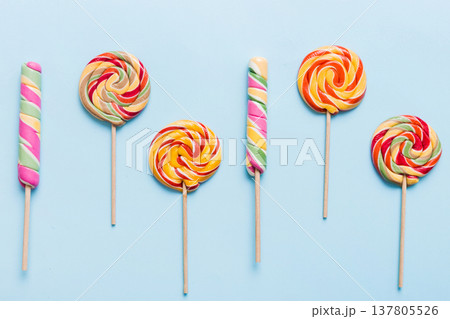Set of colorful lollipops on colored background. Summer concept. Party Happy Birthday or Minimalist Concept Set of colorful lollipops on colored background. Summer concept. Party Happy Birthday or Minimalist Concept 137805526