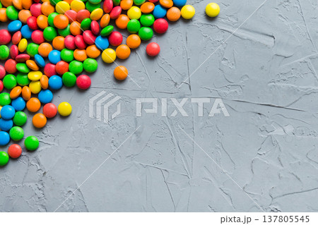 Mixed collection of colorful candy, on colored background. Flat lay, top view. frame of colorful chocolate coated candy 137805545