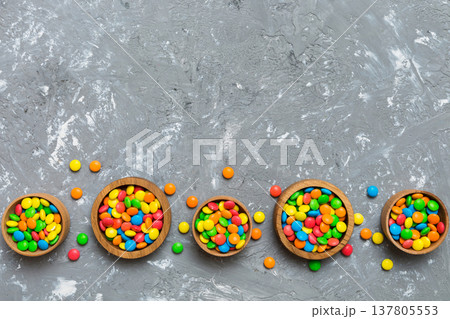 different colored round candy in bowl and jars. Top view of large variety sweets and candies with copy space 137805553