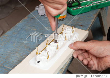 man making an extension cord socket outdoor man making an extension cord socket outdoor 137805565