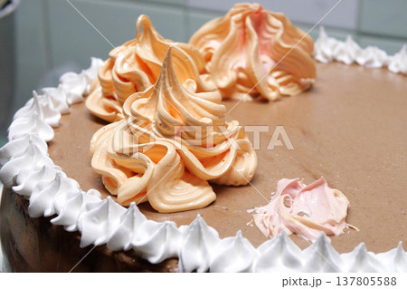 Confectioner woman is pouring cream on sponge cake using pastry bag, closeup view. Pastry chef is cooking homemade cake. cooking, baking and cooking, home cooking 137805588