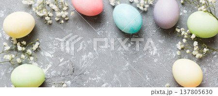 Happy Easter composition. Easter eggs on colored table with gypsophila. Natural dyed colorful eggs background top view with copy space Happy Easter composition. Easter eggs on colored table with gypsophila. Natural dyed colorful eggs background top view with copy space 137805630