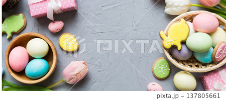 Easter frame with eggs, gift box and tulip on a colored background. The minimal concept. Top view Happy Easter composition. Card with a copy space of the place for the text 137805661