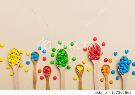 delicious colorful sweet candies on spoon on colored background . Confectionery decor top view with copy space 137805662