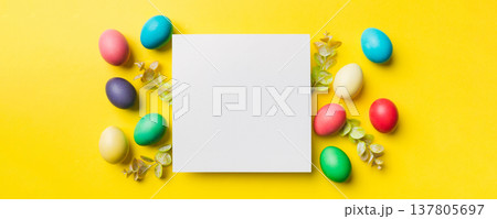 round frame multicolored Easter eggs with white blank paper on a brown background, close-up, space for text, blank for design, selective focus, tinted image 137805697