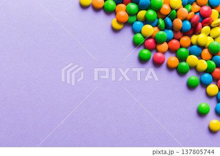 Mixed collection of colorful candy, on colored background. Flat lay, top view. frame of colorful chocolate coated candy Mixed collection of colorful candy, on colored background. Flat lay, top view. frame of colorful chocolate coated candy 137805744