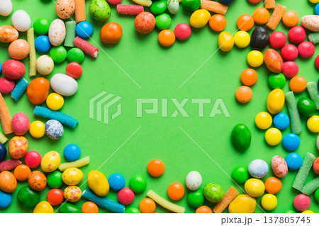 Mixed collection of colorful candy, on colored background. Flat lay, top view. frame of colorful chocolate coated candy 137805745
