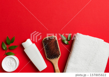 cosmetic for hair care, cream and towel on a colored background top view. flat lay cosmetic for hair care, cream and towel on a colored background top view. flat lay 137805822