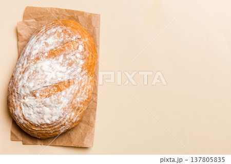 Freshly baked delicious french bread with napkin on rustic table top view. Healthy white bread loaf 137805835