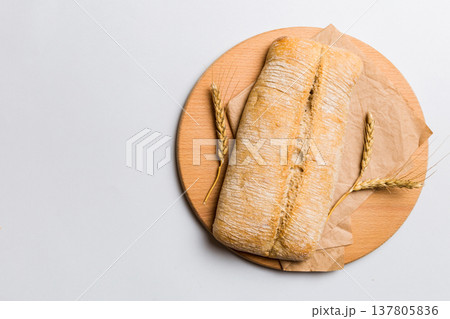 Freshly baked bread on cutting board against white wooden background. top view bread with copy space Freshly baked bread on cutting board against white wooden background. top view bread with copy space 137805836