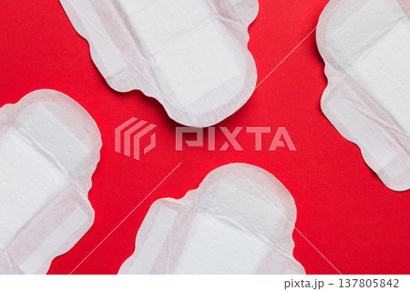 Women hygiene products or sanitary pad on colored background. Pastel color. Closeup. Empty place for text. Female daily hygiene Women hygiene products or sanitary pad on colored background. Pastel color. Closeup. Empty place for text. Female daily hygiene 137805842