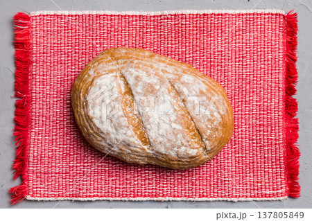 Freshly baked delicious french bread with napkin on rustic table top view. Healthy white bread loaf Freshly baked delicious french bread with napkin on rustic table top view. Healthy white bread loaf 137805849