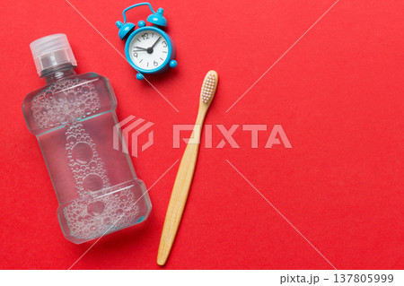 Mouthwash and other oral hygiene products on colored table top view with copy space. Flat lay. Dental hygiene. Oral care products and space for text on light background. concept 137805999