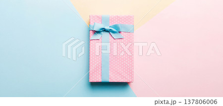 holiday handmade paper present tied blue ribbon bow top view with copy space. Flat lay holiday background. Birthday or christmas present. Christmas gift box concept with copy space holiday handmade paper present tied blue ribbon bow top view with copy space. Flat lay holiday background. Birthday or christmas present. Christmas gift box concept with copy space 137806006