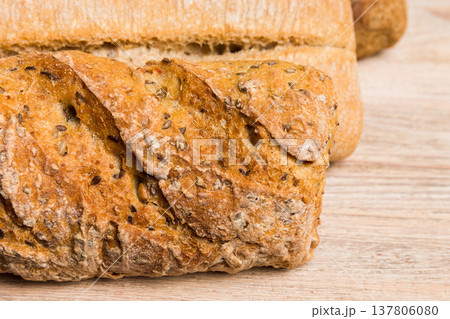 Homemade natural breads. Different kinds of fresh bread as background, perspective view with copy space Homemade natural breads. Different kinds of fresh bread as background, perspective view with copy space 137806080