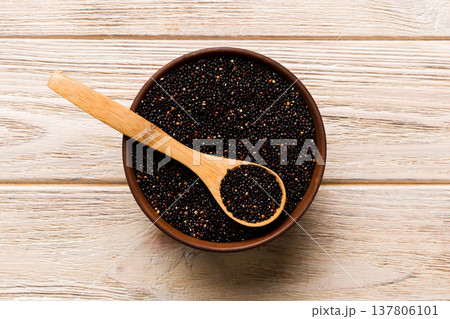 quinoa seeds in bowl and spoon on colored background. Healthy kinwa in small bowl. Healthy superfood 137806101