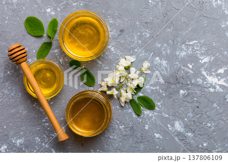 honey jar with acacia flowers and leaves. fresh honey top view flat lay honey jar with acacia flowers and leaves. fresh honey top view flat lay 137806109