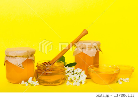 robinia honey bollte with acacia blossoms on colored table robinia honey bollte with acacia blossoms on colored table 137806113