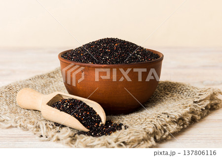 quinoa seeds in bowl and spoon on colored background. Healthy kinwa in small bowl. Healthy superfood 137806116
