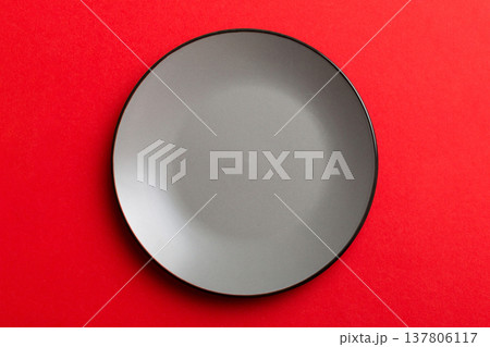 Top view of isolated of colored background empty round gray plate for food. Empty dish with space for your design Top view of isolated of colored background empty round gray plate for food. Empty dish with space for your design 137806117