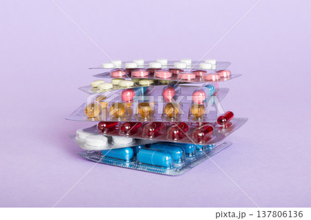 too many different pill cartridges stacked. selective Focus. Packs of blister pills with tablets. Colored pastilles packages. A pile of medicine in blister packs. Pharmaceutical blister packs 137806136