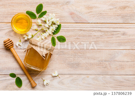 honey jar with acacia flowers and leaves. fresh honey top view flat lay honey jar with acacia flowers and leaves. fresh honey top view flat lay 137806239