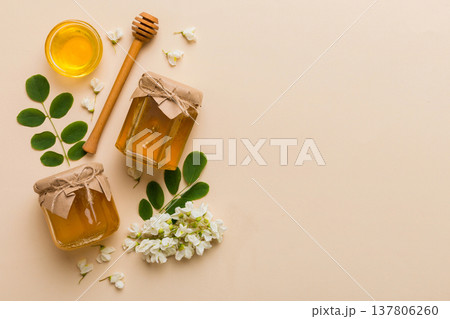 honey jar with acacia flowers and leaves. fresh honey top view flat lay honey jar with acacia flowers and leaves. fresh honey top view flat lay 137806260