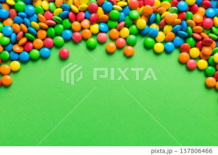 Mixed collection of colorful candy, on colored background. Flat lay, top view. frame of colorful chocolate coated candy Mixed collection of colorful candy, on colored background. Flat lay, top view. frame of colorful chocolate coated candy 137806466