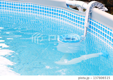 Top view of the blue skimmer for cleaning the pool in clear water. Contaminated pool cleaning concept Top view of the blue skimmer for cleaning the pool in clear water. Contaminated pool cleaning concept 137806515