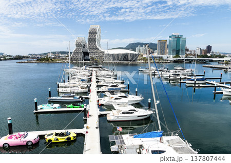View of Argo Yacht Marina at Glory Pier of Kaohsiung Port, Taiwan, and the Kaohsiung Music Center building. View of Argo Yacht Marina at Glory Pier of Kaohsiung Port, Taiwan, and the Kaohsiung Music Center building. 137807444