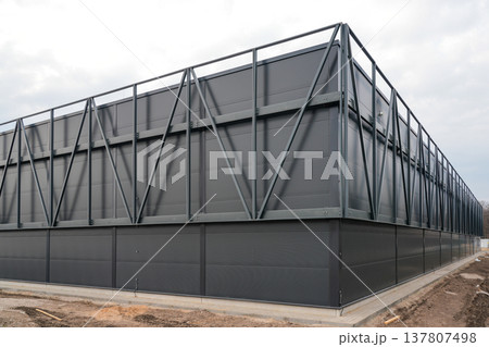 Modern Industrial Warehouse Exterior with Steel Frame Structure and Dark Metal Facade Panels Modern Industrial Warehouse Exterior with Steel Frame Structure and Dark Metal Facade Panels 137807498