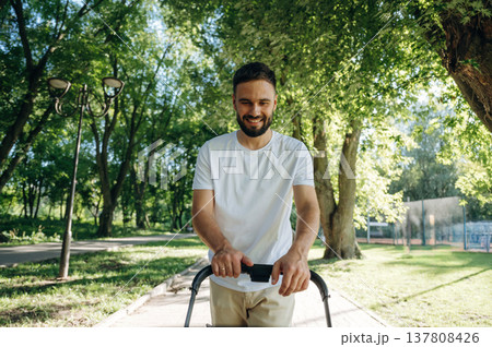 Very happy, parenting conception. Father is with cradle, having a walk in the park 137808426