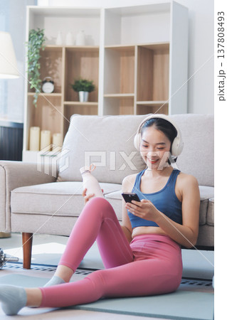 Young Asian sporty attractive people practicing yoga lesson with instructor. Asia group of women exercising healthy lifestyle in fitness studio. Sport activity, gymnastics or ballet dancing class. 137808493